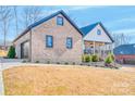 Brick home and detached garage featuring well-maintained landscaping and exterior details at 1509 Avalon Oaks Ct, Dallas, NC 28034