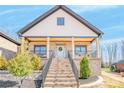 Inviting front porch with brick stairs and railing leading to the front door of the beautiful brick home at 1509 Avalon Oaks Ct, Dallas, NC 28034