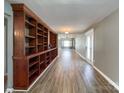 Spacious living room featuring hardwood floors and a built-in shelving unit for storage and decor at 1589 E Lakewood Dr, Rock Hill, SC 29732