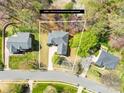 Aerial view of the property, showing the house with lot lines and surrounding trees at 171 Longboat Rd, Mooresville, NC 28117