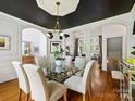 Spacious dining room featuring a glass table, modern lighting, and an open layout at 19000 Hodestone Mews Ct, Davidson, NC 28036