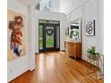 Bright foyer with hardwood floors, a modern door, and a high ceiling, creating an inviting entrance at 19000 Hodestone Mews Ct, Davidson, NC 28036
