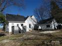 Backyard view features a deck with stairs plus outbuilding with matching trim and roof at 201 W Rice St, Landis, NC 28088