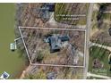 Aerial view of a lakeside property with lush surroundings and a private dock, with the lot lines displayed at 213 Patternote Rd, Mooresville, NC 28117