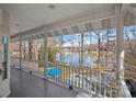 A beautiful lake view from a spacious covered porch with white railings, perfect for enjoying the scenery at 213 Patternote Rd, Mooresville, NC 28117