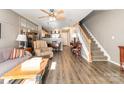 Comfortable living room featuring hardwood floors, staircase and neutral color palette at 2511 Brackley Nw Pl # 1013, Concord, NC 28027