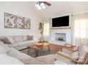 Bright living room with hardwood floors, vaulted ceilings, white brick fireplace, and neutral décor at 2520 Foxworth Dr, Monroe, NC 28110