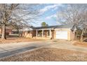 A full front exterior of a single story brick home with covered entry and attached garage at 2888 Robinson Rd, Newton, NC 28658