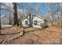 Side yard featuring a stone path and mature trees at 3929 Fernleaf Ct, Charlotte, NC 28215
