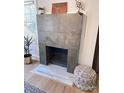 Close up on a fireplace with gray concrete blocks and stylish decor at 4317 Ruskin Dr, Charlotte, NC 28209