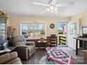 Inviting living room with neutral paint, vinyl flooring, and comfortable seating beneath a ceiling fan at 506 Bond St, Cherryville, NC 28021