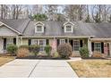 Attractive townhome featuring dormer windows and an American flag in a well-kept front yard at 543 Weavers Xing, Fort Mill, SC 29715