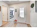 Bright entryway featuring wood-look flooring, a white door with frosted glass, and views into the bedroom at 908 Morien St, Richburg, SC 29729