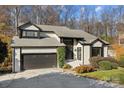 Charming gray brick home with a two-car garage, black trim, mature landscaping and well-maintained lawn at 9334 Hunting Ct, Matthews, NC 28105
