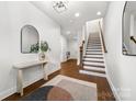 Foyer showcasing hardwood floors, white walls, a staircase and an area for a bench at 110 Wesser St, Davidson, NC 28036