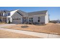 Charming single-story home with a well-manicured lawn, inviting curb appeal at 11031 Larkslea Ln, Charlotte, NC 28278