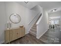 Inviting entryway with a staircase, stylish accent furniture, decorative mirror, and attractive flooring at 113 Briana Marie Way, Indian Trail, NC 28079