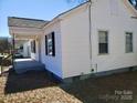 Charming white home with a covered porch and black shutters on the windows at 116 Nella St, Chester, SC 29706