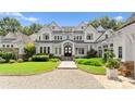 Stunning lakefront home showcasing well-kept lawn, meticulous landscaping and architectural excellence at 124 Wellcraft Ct, Mooresville, NC 28117