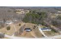 Aerial view of property showcasing the home's setting amid surrounding trees and a sprawling lawn at 125 Crescent Heights Dr, Salisbury, NC 28146