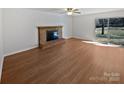 Open living room boasts hardwood floors, natural light, and a classic brick fireplace at 125 Newport Dr, Salisbury, NC 28144