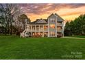 Expansive backyard featuring multi-story porch and spacious lawn at 12860 Westmoreland Farm Rd, Davidson, NC 28036