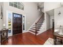 Inviting foyer featuring hardwood floors, staircase, and ample natural light at 12860 Westmoreland Farm Rd, Davidson, NC 28036