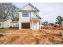 New construction home with vinyl siding, black trim windows, covered front entry and attached one car garage at 160 S Sycamore St, Mooresville, NC 28115