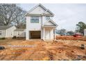 New construction featuring white siding and dark roof with a covered front entryway and attached garage at 162 S Sycamore St, Mooresville, NC 28115