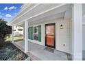 Inviting front porch with green shutters, a welcome mat, and hanging plants near the home's entry at 1766 Canebrook Gln, York, SC 29745