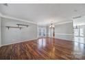 Spacious living room with hardwood floors, crown molding, a bay window, and an elegant chandelier at 1766 Canebrook Gln, York, SC 29745