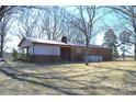 Back exterior view of a brick home with an attached carport and a fenced yard at 1886 Buffalo Shoals Rd, Statesville, NC 28677