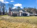 Charming brick home featuring a new roof, well-maintained landscaping, and a welcoming front entrance at 2100 Lincolnton Hwy, Cherryville, NC 28021