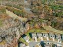 Aerial view of the neighborhood surrounded by lush trees and a serene lake, showcasing community beauty at 2894 Westshore Pl, Denver, NC 28037