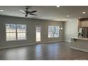Bright living room with luxury vinyl flooring and large windows overlooking the backyard at 2924 Noritake Trl # 59, Albemarle, NC 28001