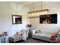 Elegant living room showcasing stylish decor, including a chaise lounge and modern lighting at 3309 Juneberry Pl, Indian Land, SC 29707