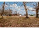 Spacious front yard with a brick home, large trees, and a long driveway leading to an attached garage at 342 Monticello Rd, Statesville, NC 28625