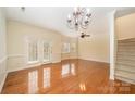 Spacious living room with hardwood floors, ceiling fan, and natural light from French doors and windows at 349 Valley Brook Se Ln, Concord, NC 28025