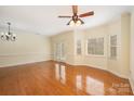 Bright living room featuring hardwood floors, a ceiling fan, and access to a patio via French doors at 349 Valley Brook Se Ln, Concord, NC 28025