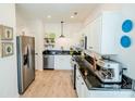 Modern kitchen features stainless steel appliances, white cabinets, and granite countertops at 4022 Carl Parmer Dr, Harrisburg, NC 28075