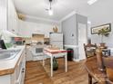 Bright kitchen featuring white cabinets, appliances, and wood-look flooring at 405 Wilson N St, Rock Hill, SC 29730