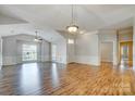 Bright, open living room with hardwood floors, crown molding, and a vaulted ceiling at 6038 Burnt Mill Run, Matthews, NC 28104