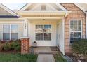 Cozy front porch with brick accents, inviting entrance, and well-maintained landscaping at 605 Gable Dr, Rock Hill, SC 29732