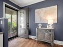 Stylish entryway featuring hardwood floors, gray walls, and elegant decor with a view of the porch at 6349 Lebanon Rd, Mint Hill, NC 28227