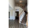 Bright foyer featuring hardwood floors, staircase, and ample natural light at 6827 Neuhoff Ln, Charlotte, NC 28269