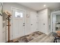 Bright foyer showcasing light wood floors, a decorated front door, and convenient coat rack at 715 Bonica Ct, Lancaster, SC 29720