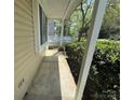 Covered front porch with concrete flooring and view of the surrounding neighborhood at 7939 Holly Hill Rd, Charlotte, NC 28227
