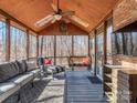 Inviting screened porch with comfortable seating and a ceiling fan at 8111 Sealey Ct, Charlotte, NC 28277