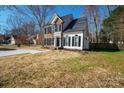 Well-maintained two-story home with brick and vinyl siding, black shutters, and a spacious front yard at 8733 Canter Post Dr, Charlotte, NC 28216