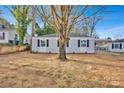 Charming single-story home featuring light gray siding, black shutters and a mature shade tree at 1008 Bose Ave, Rock Hill, SC 29732